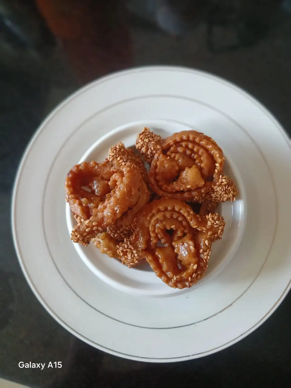 A close-up of traditional Moroccan Halwa Chebakia, deep-fried sesame cookies coated in honey and sprinkled with sesame seeds.